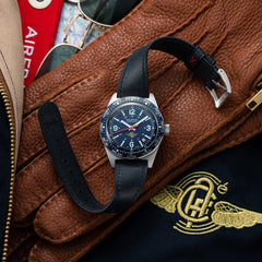 Wolbrook Skindiver WT Automatic Aéro-Club de France Special Edition watch with blue leather strap on brown leather gloves